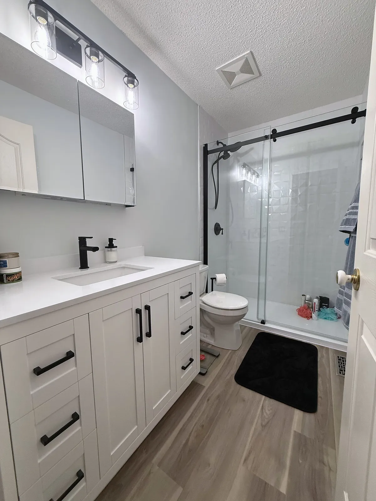 Signal Hill bathroom with long white vanity and black shower hardware