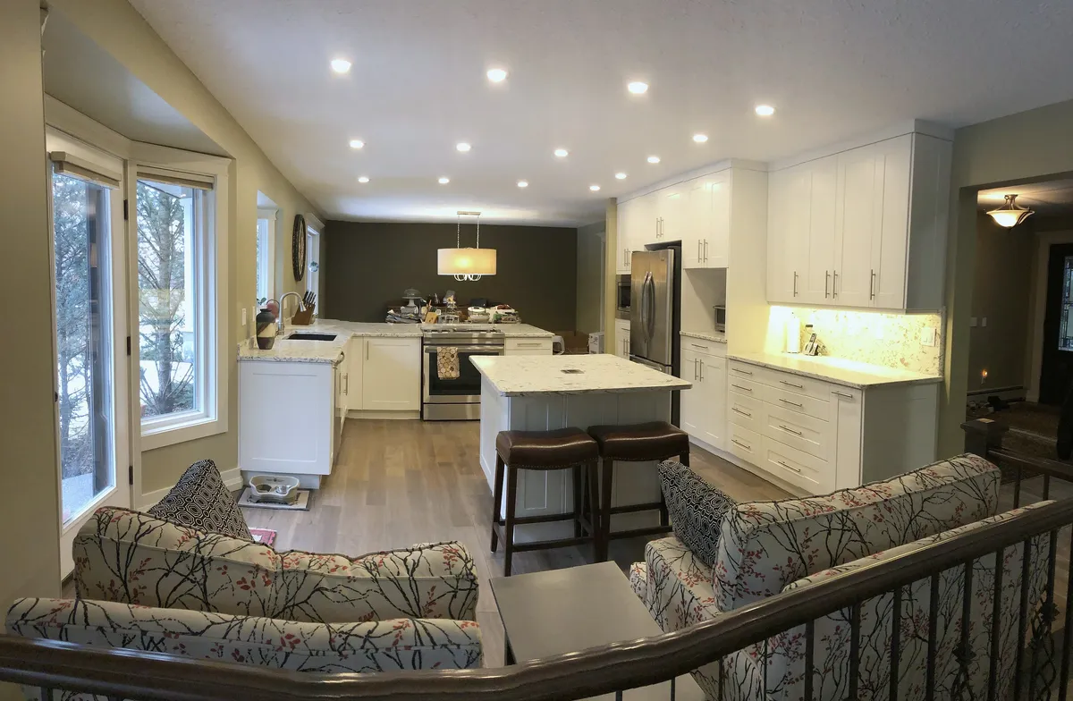 Open Edgemont main floor with white kitchen cabinetry and a long island