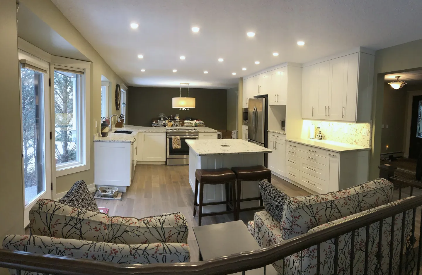 Open Edgemont main floor with white kitchen cabinetry and a long island