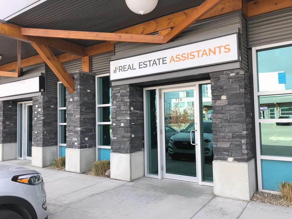 Real Estate Assistants office entrance with timber canopy and company sign