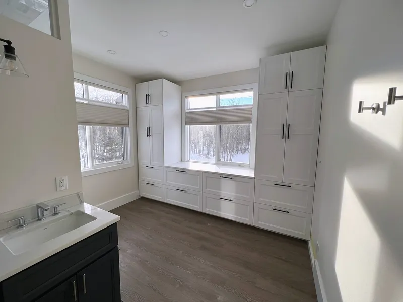 White built-in storage surrounding the Bearspaw ensuite windows
