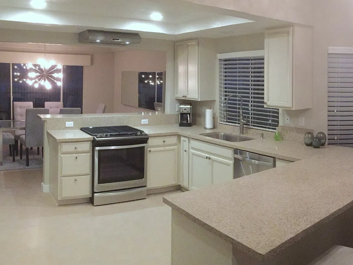 Light kitchen cabinetry and broad peninsula in the Calgary Palm Springs project