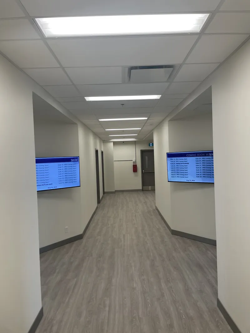 Finished Social Beauty Studios corridor with salon directory screens and coordinated flooring