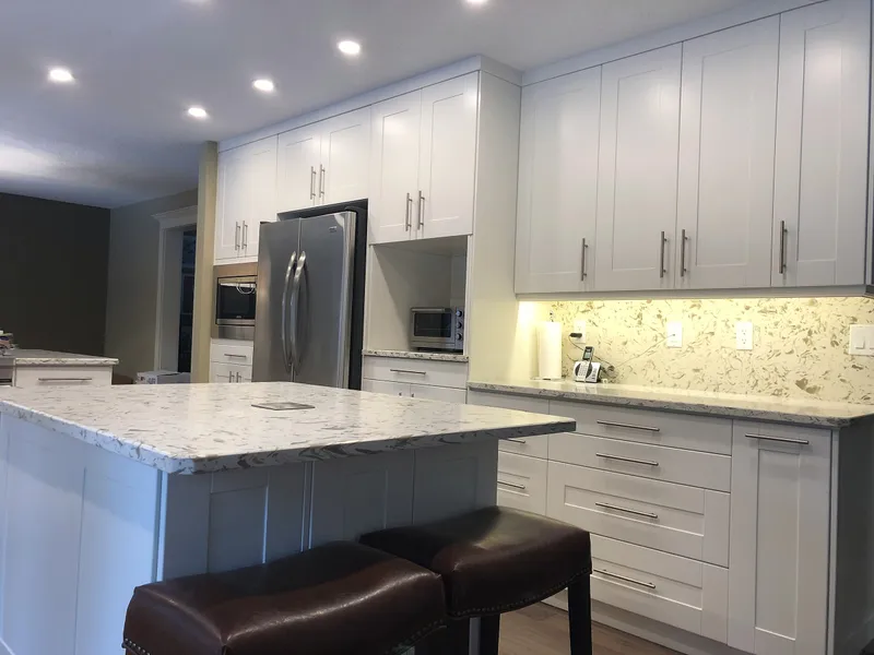 Edgemont kitchen with a stainless refrigerator and illuminated backsplash