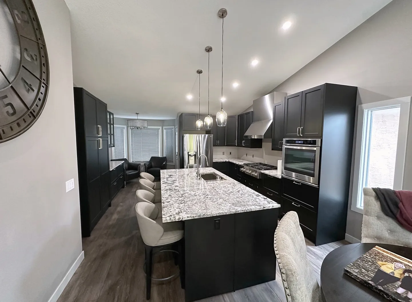 Long kitchen island with seating in the renovated Harvest Hills main floor
