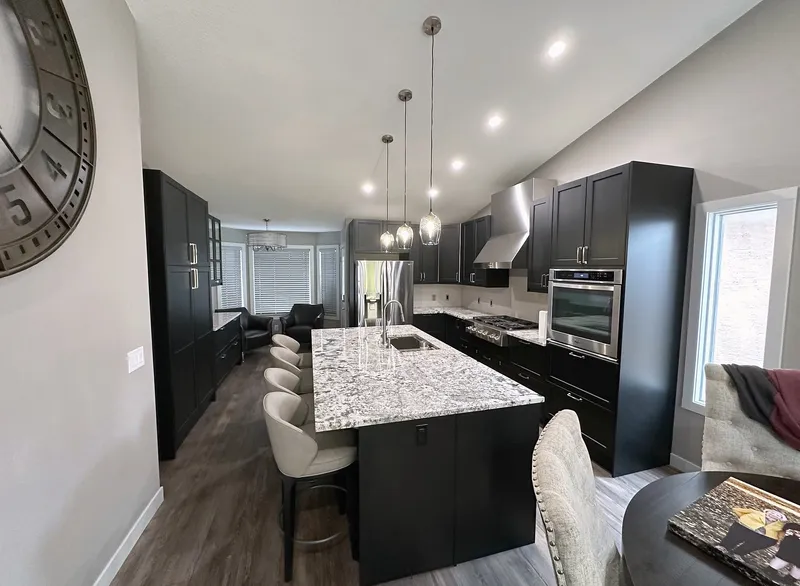 Long kitchen island with seating in the renovated Harvest Hills main floor