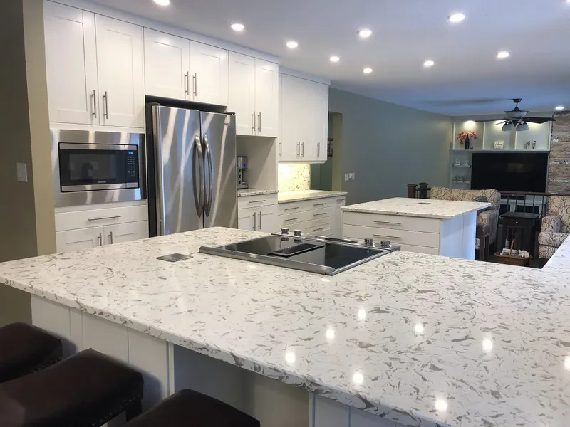 Stone kitchen peninsula with cooktop in the renovated Edgemont home