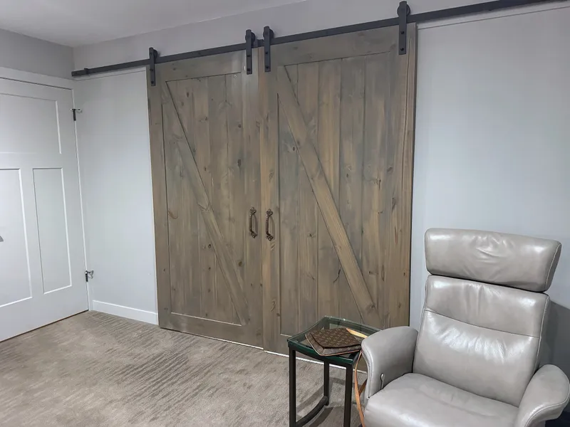 Double wood sliding barn doors with black hardware at Artists View
