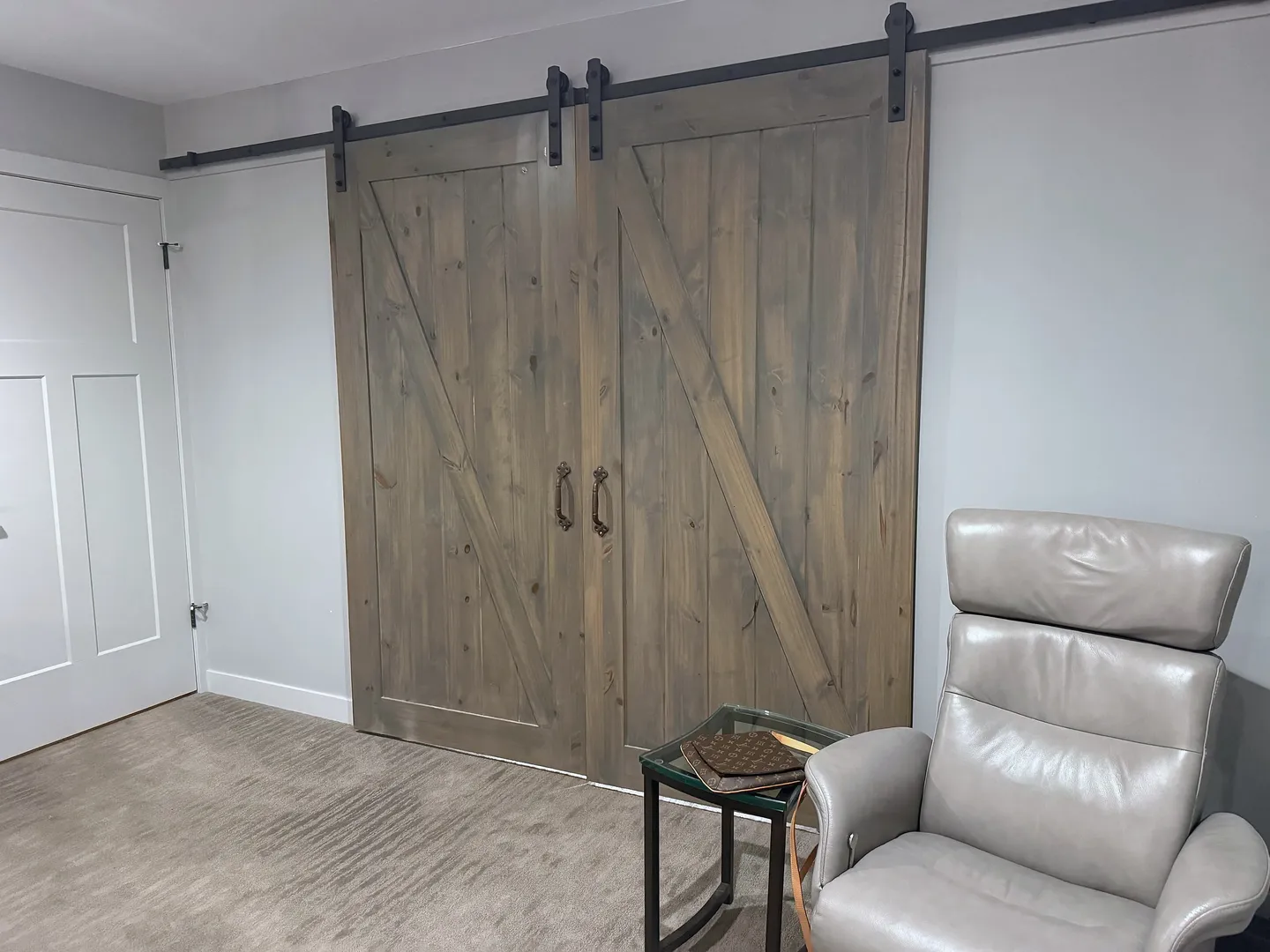 Double wood sliding barn doors with black hardware at Artists View