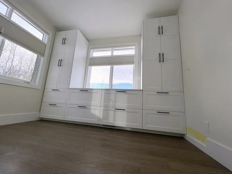 Floor-to-ceiling white cabinets in the Bearspaw ensuite