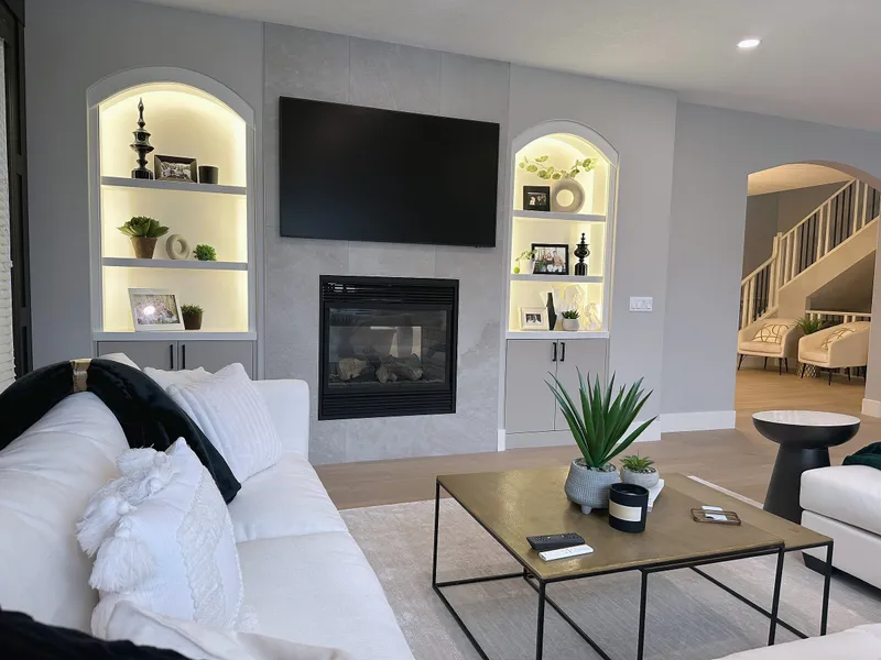Wentworth living-room fireplace and lit display niches beside the staircase