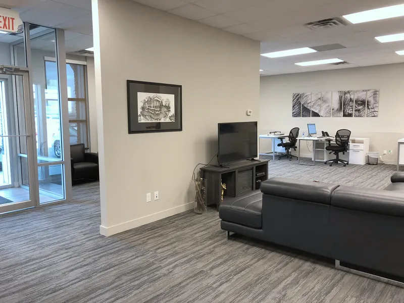 Open office workstations beside the client lounge