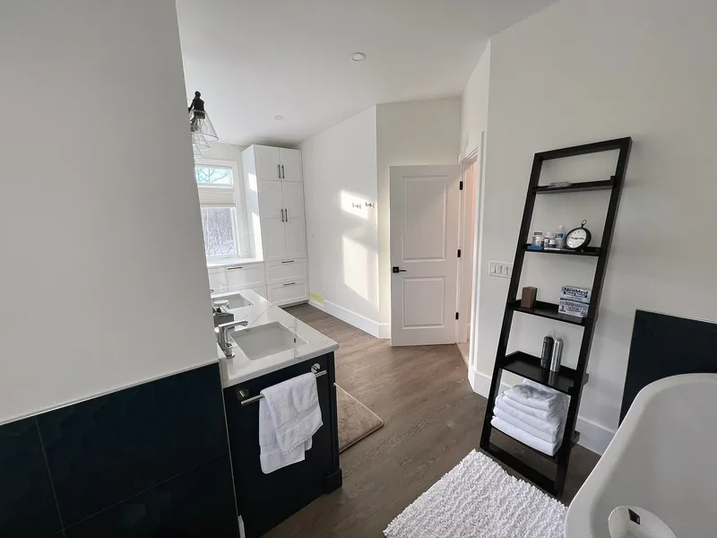 Dark vanity and open floor space in the Bearspaw ensuite