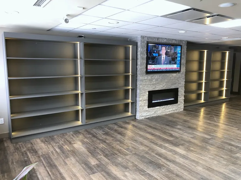 Angled view of the Silver Springs stone fireplace and display shelving