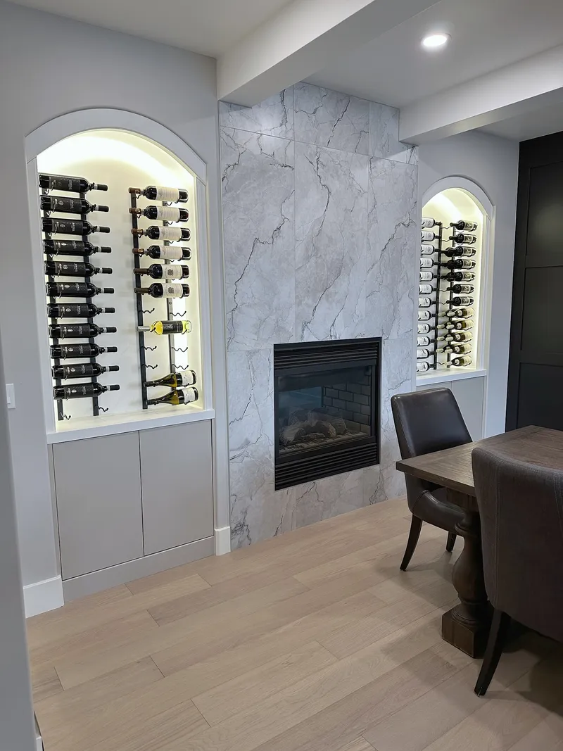 Wentworth dining-room fireplace with stone surround and arched wine storage