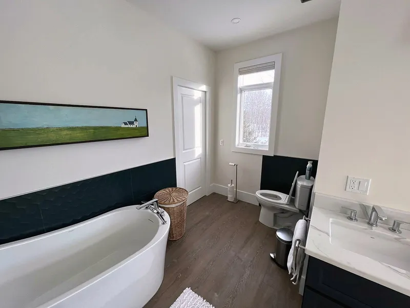 Freestanding tub, vanity and tall storage cabinet in the Bearspaw ensuite