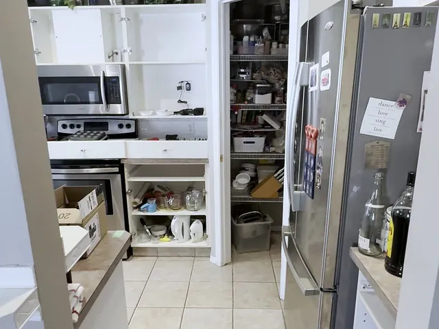 Original Hamptons kitchen with open cabinet storage and tiled floor