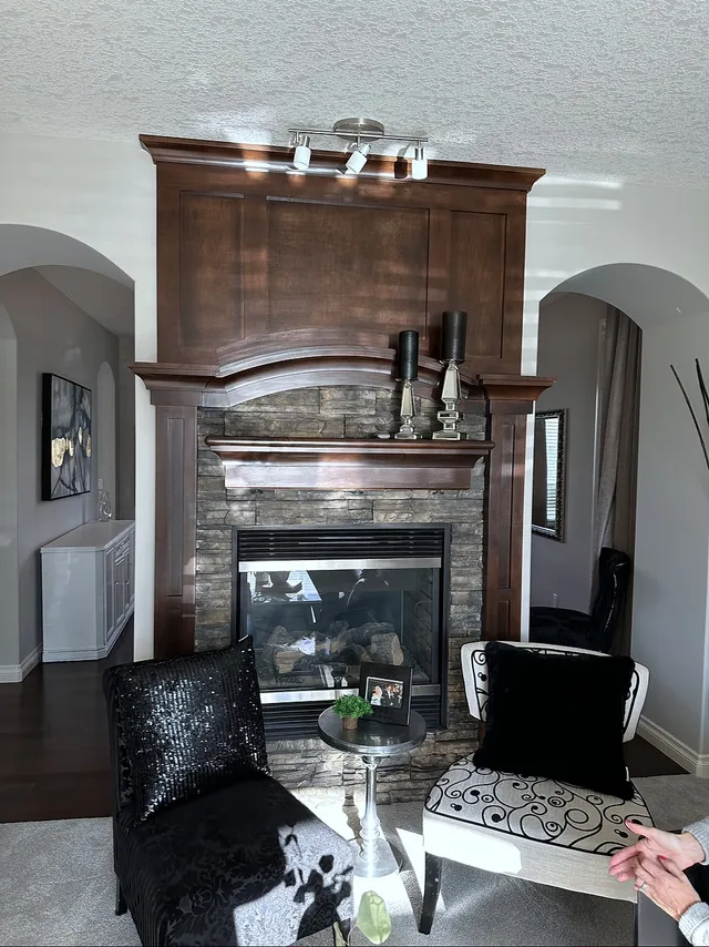 Original dark wood fireplace and arched niches in the Wentworth dining room