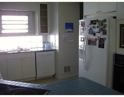 Original Upper Scarboro kitchen cabinetry and refrigerator