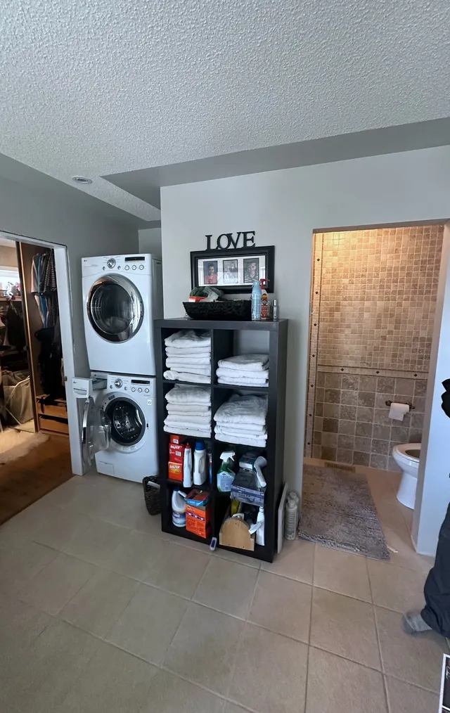 Original McKenzie Towne ensuite with stacked laundry and open storage