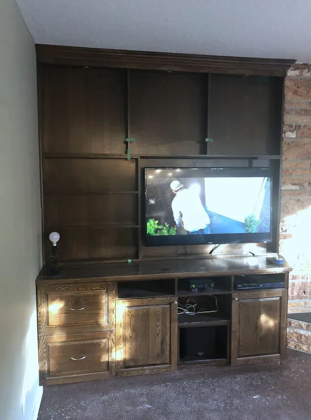 Original dark wood fireplace and television surround in Edgemont
