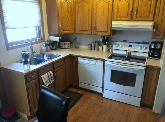 Original wood cabinetry and laminate counters in the Harvest Hills kitchen
