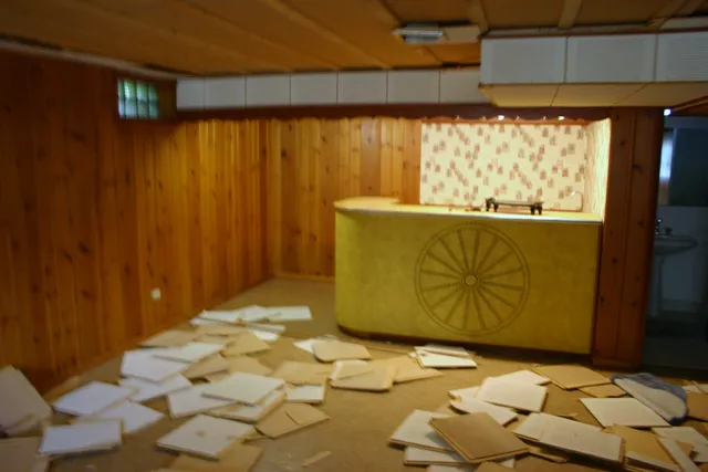 Wood-panelled basement and bar before renovation
