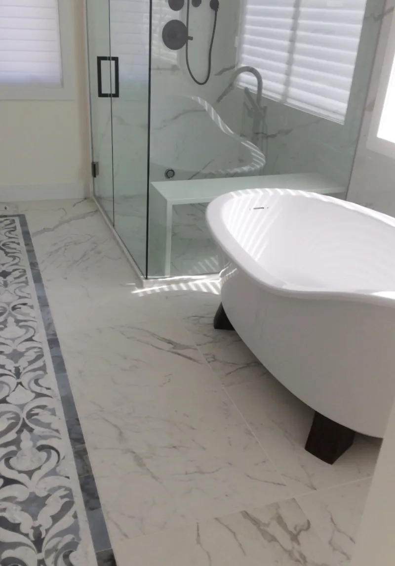 Freestanding tub and glass shower with patterned floor tile