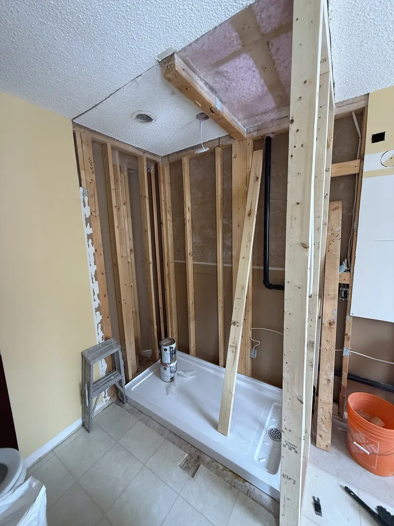 Exposed bathroom wall framing during the Signal Hill renovation