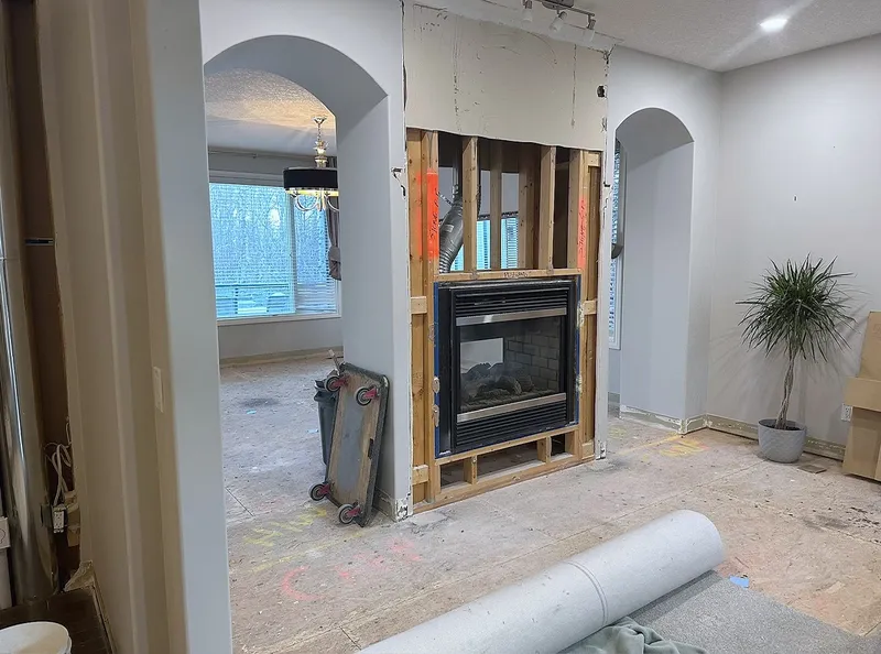 Dining-room fireplace wall opened to its framing in Wentworth
