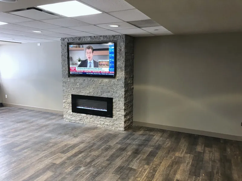 Completed stone fireplace before installation of the club display shelves