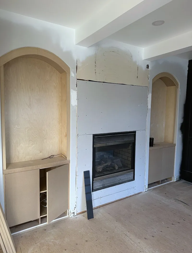 Wentworth living-room fireplace wall during drywall installation